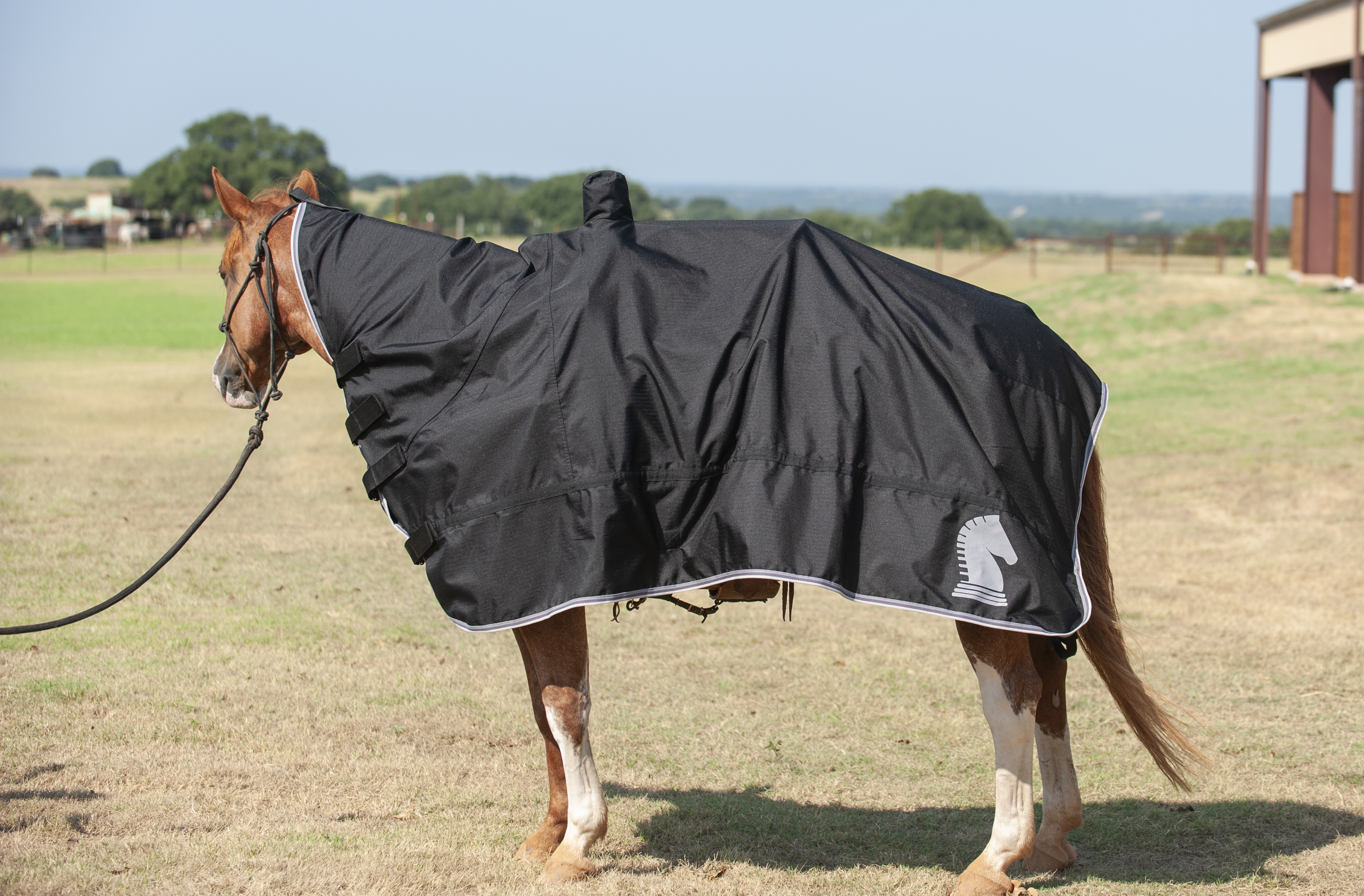 Waterproof horse and saddle cover with nylon tail strap,
              protects leather tack from rain damage